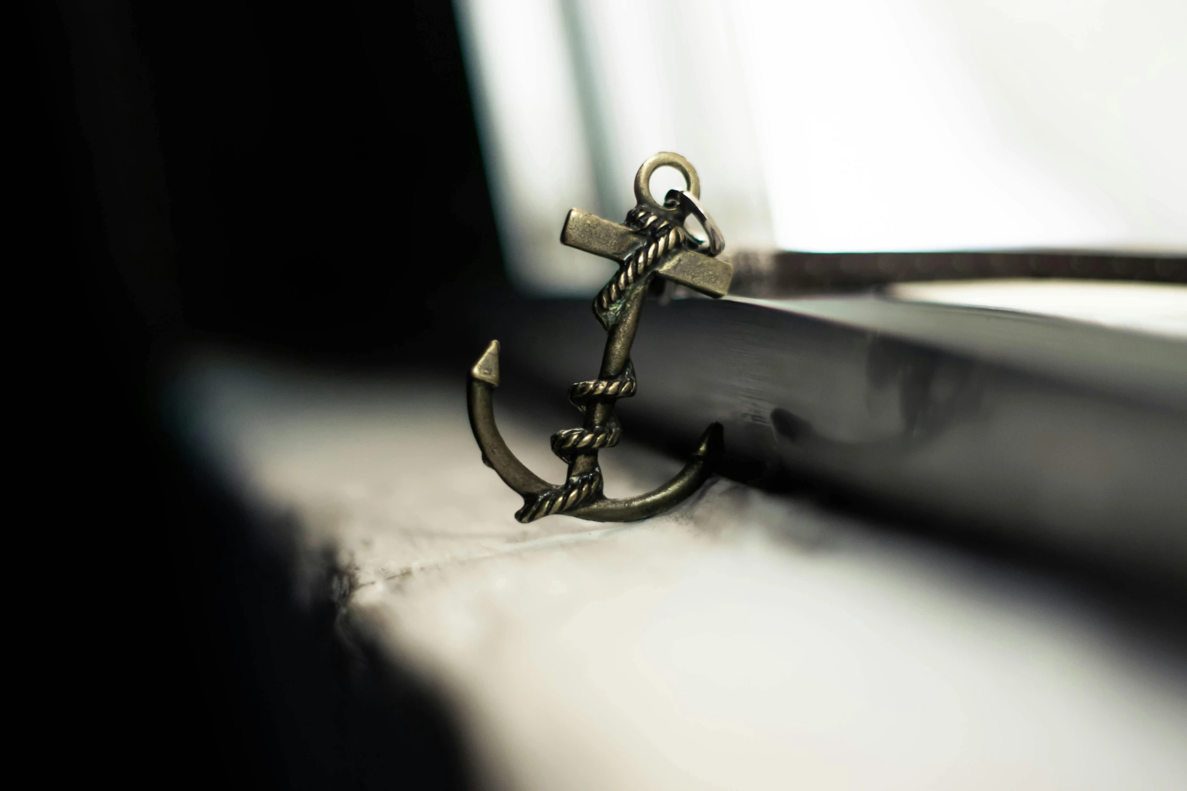 a close up of an anchor on a window sill, a tattoo, trending on pexels, brass plated, detailed jewellery, studio shot, multiple stories