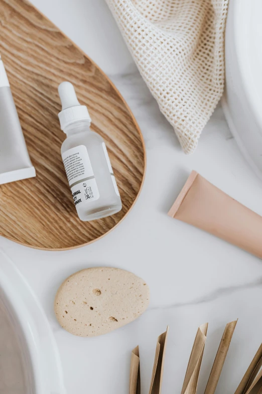 a variety of skin care products laid out on a table, trending on unsplash, modern earthy neutral earthy, white studio background, silicone skin, detailed product image