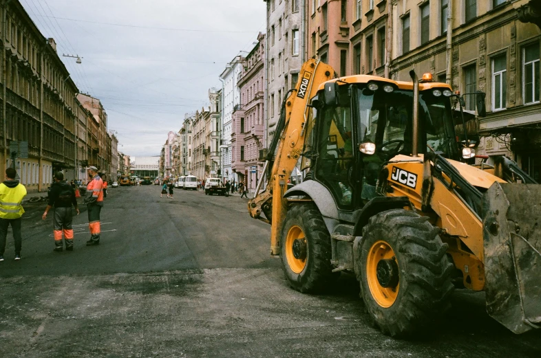 a construction vehicle parked on the side of a road, by Matija Jama, pexels contest winner, constructivism, dingy city street, jcb, background image