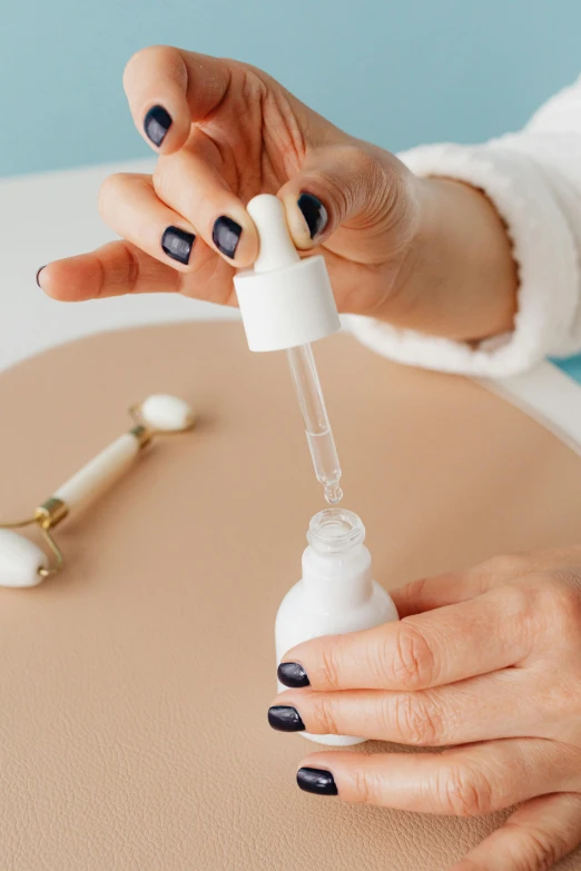 a woman using a hand sanitizer to clean her hands, a photorealistic painting, by Julia Pishtar, trending on pexels, candle dripping white wax, miniature product photo, syringe, white