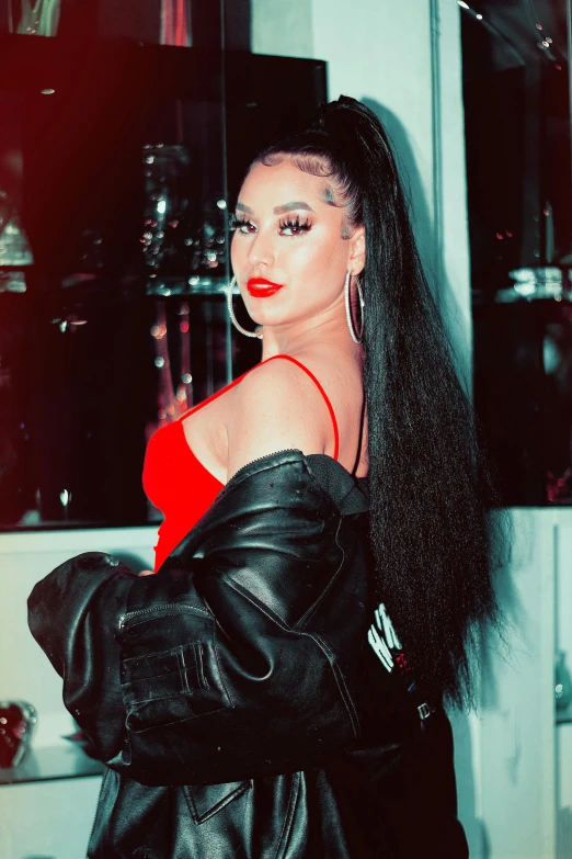 a woman with long black hair wearing a red dress, an album cover, inspired by Rowena Meeks Abdy, trending on pexels, bad bunny, long black ponytail, prideful look, heavy grainy picture