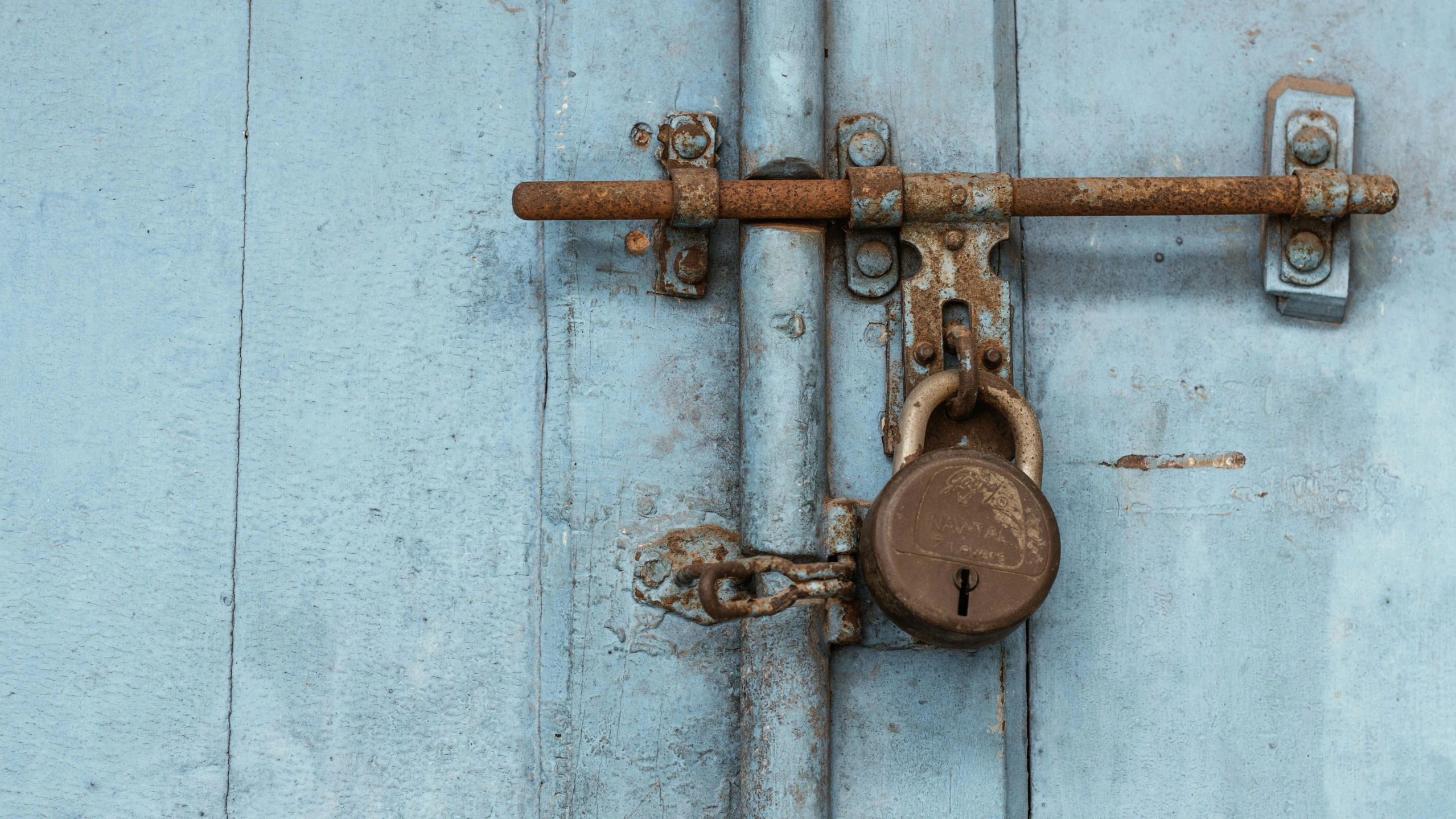 a close up of a lock on a door, an album cover, by Adam Marczyński, pexels contest winner, private press, cerulean blue and burnt sienna, plain background, the shackled, thumbnail