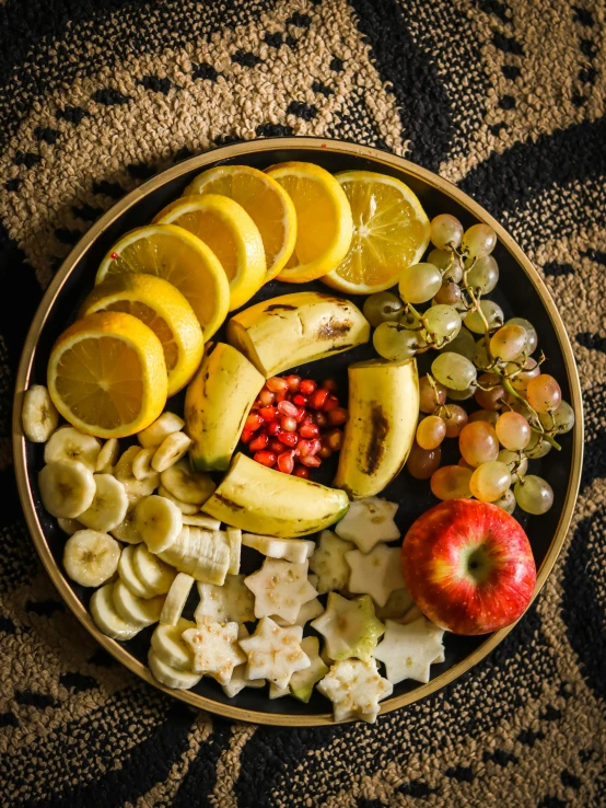 a bowl filled with fruit sitting on top of a table, banana, offering a plate of food, thumbnail, snacks