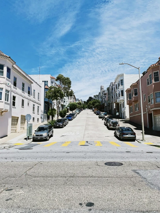 a street filled with lots of parked cars, by Carey Morris, unsplash, renaissance, built on a steep hill, golden gate, 🚿🗝📝