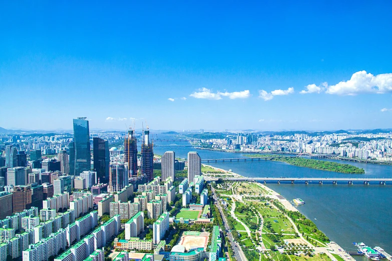 a view of a city with lots of tall buildings, by Jang Seung-eop, pexels contest winner, bright sunny summer day, drone footage, wide angle river, slide show