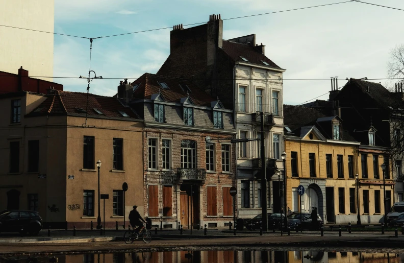 a group of buildings next to a body of water, by Jan Tengnagel, pexels contest winner, renaissance, in muted colours, street corner, belgium, slide show