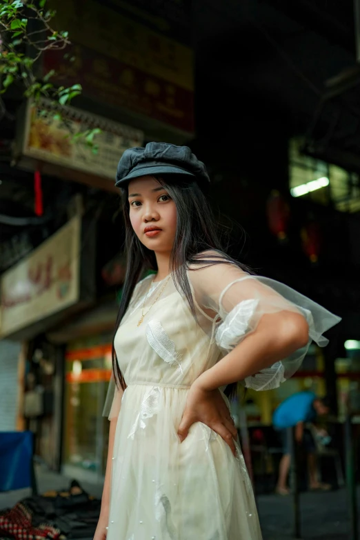 a woman in a white dress and a hat, inspired by Wen Boren, unsplash, realism, bangkok townsquare, baggy clothing and hat, sheer, female with long black hair