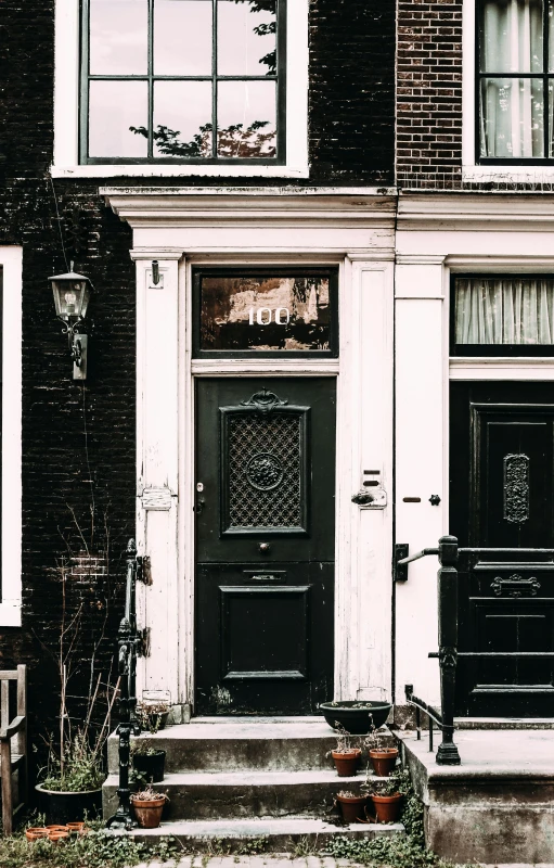 a black and white photo of a house, by Jacob Toorenvliet, pexels, art nouveau, door to lab, amsterdam, black and brown colors, banner