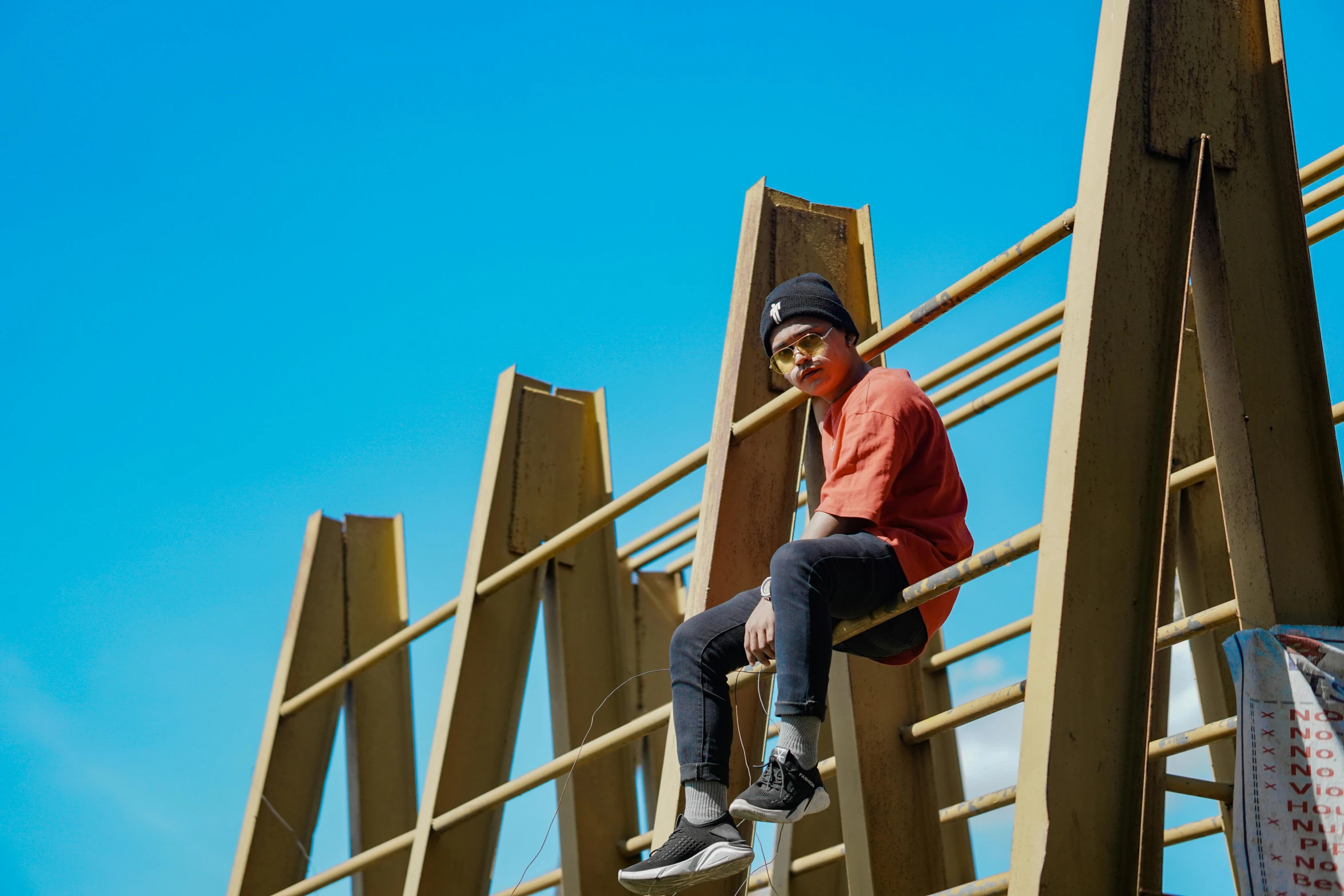 a person sitting on top of a wooden structure, shot on sony a 7, streetwear, rectangle, construction