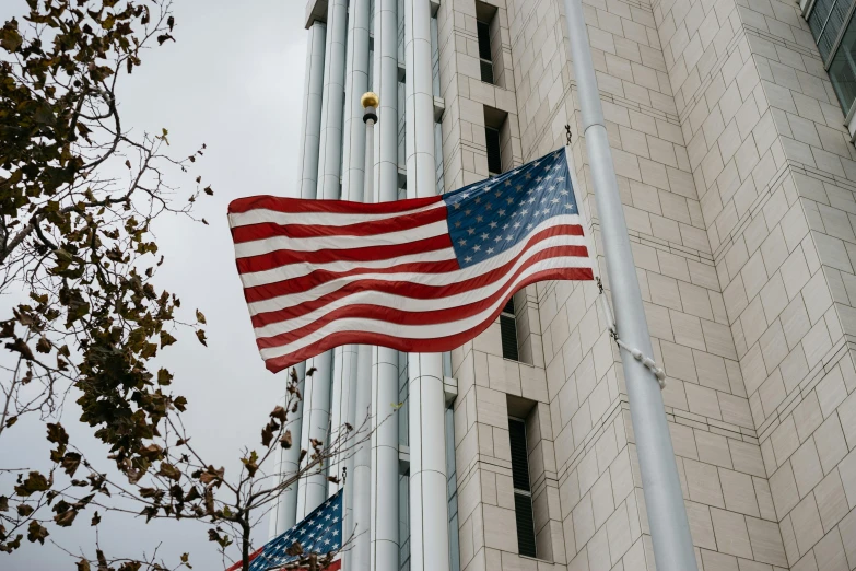 an american flag flying in front of a tall building, unsplash, hurufiyya, instagram picture, profile image, three - quarter view, 2000s photo