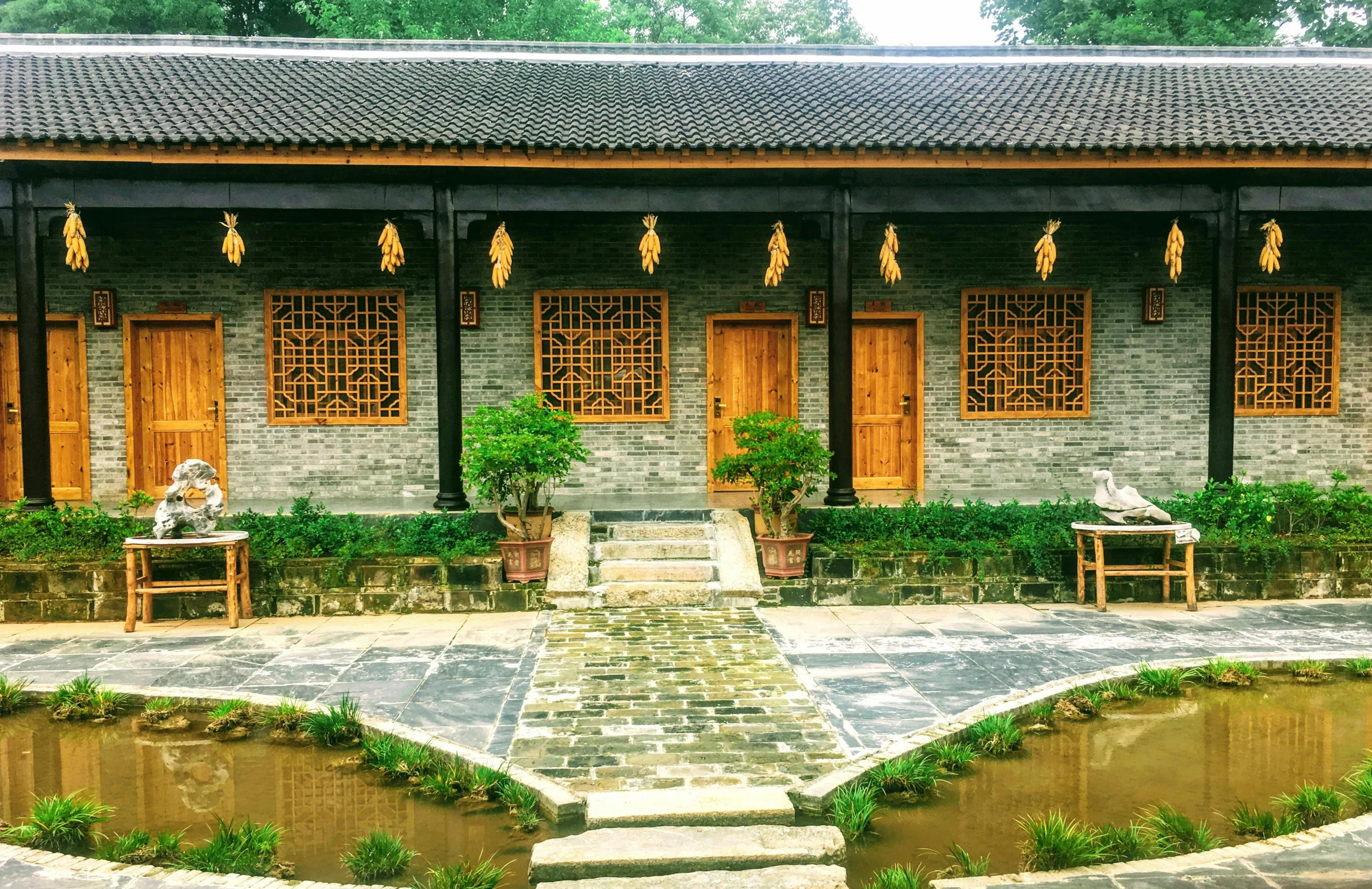 a couple of benches sitting in front of a building, inspired by Wang Yi, pexels contest winner, tiled room squared waterway, farmhouse, guangjian huang, grey