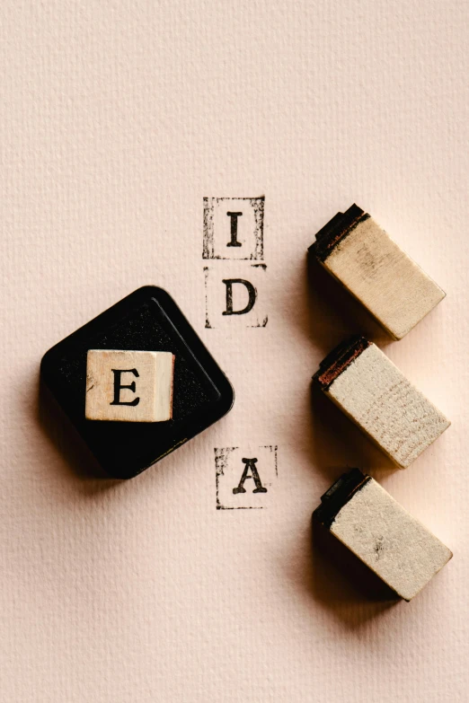 a couple of wooden blocks sitting next to each other, a picture, unsplash, edison bulb, concrete poetry, rubber stamp, thumbnail