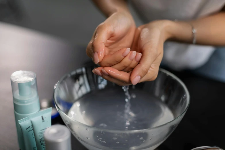 a person washing their hands in a bowl, a photorealistic painting, trending on pexels, frying nails, hydration, professional, blending