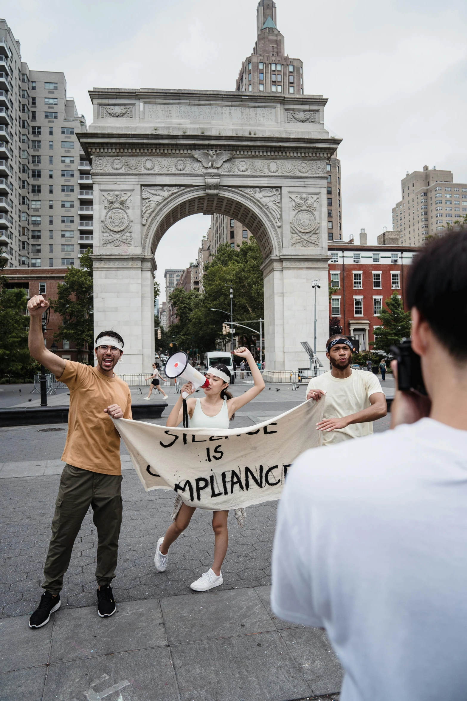 a group of people holding a banner on a city street, a statue, by Nina Hamnett, trending on unsplash, new york times, actors, celebrating an illegal marriage, riot shields