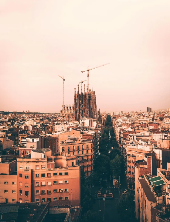 a view of a city from the top of a building, inspired by Tomàs Barceló, pexels contest winner, art nouveau, brown and magenta color scheme, cathedral in the background, frank gehry, instagram picture