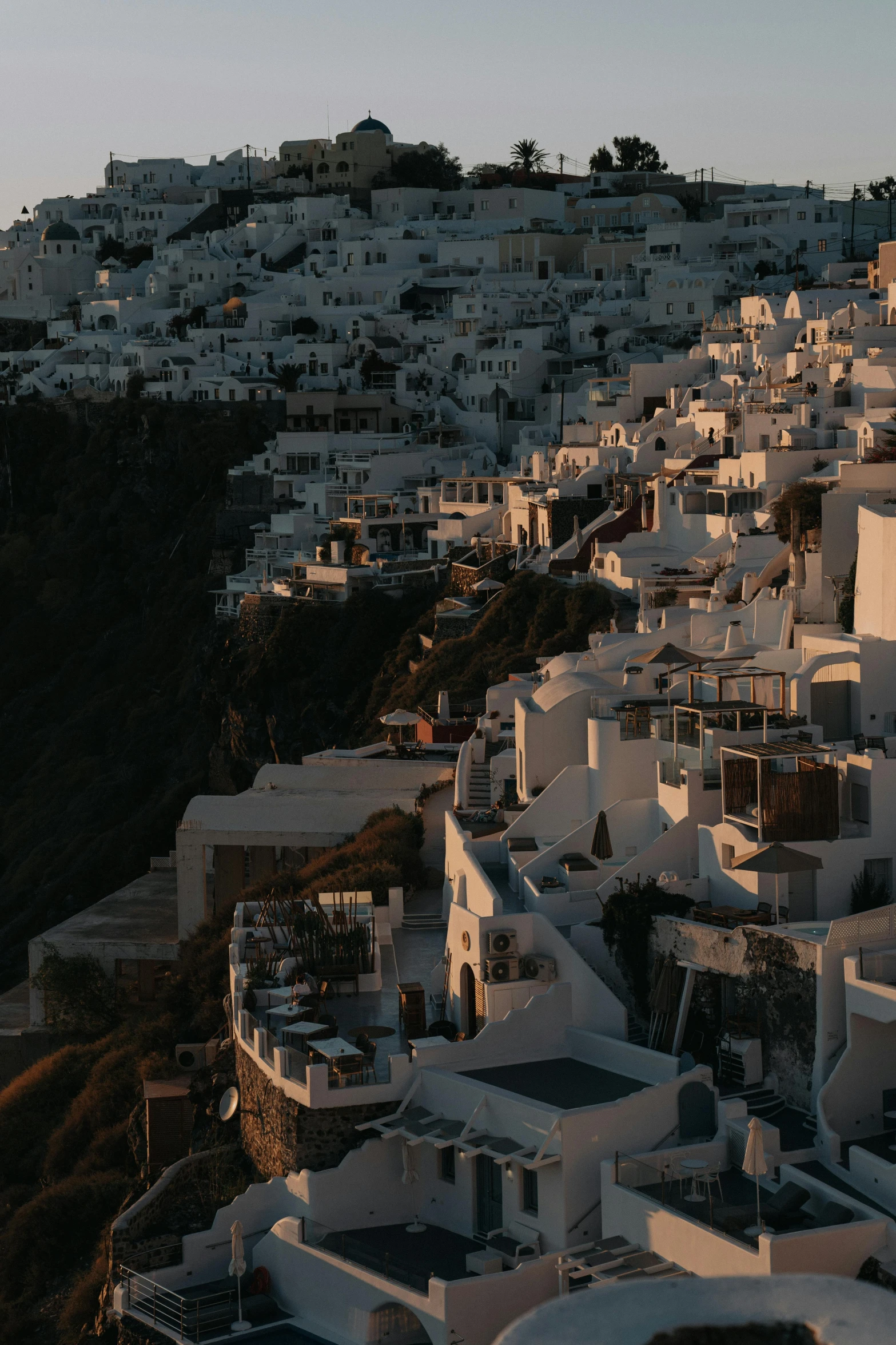 a view of a town from the top of a hill, by Alexis Grimou, unsplash contest winner, santorini, late summer evening, gif, terraced