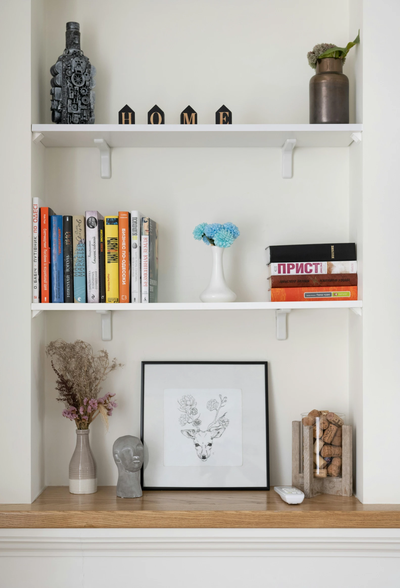 a shelf with books and vases on it, recessed, art set, top lit, location in a apartment