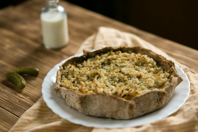 a close up of a pie on a plate on a table, inspired by Géza Dósa, hurufiyya, hemp, soviet - era, inside a cavernous stomach, big oatmeal