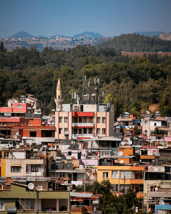 a view of a city from the top of a hill, by Alejandro Obregón, nepali architecture buildings, standing on a rooftop, full of colour, slide show