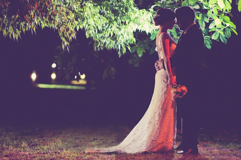 a bride and groom standing under a tree at night, pexels, romanticism, graphic”, rectangle, vintage glow, romantic ambiente