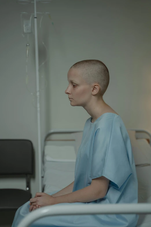 a man sitting on a hospital bed in a hospital room, by Attila Meszlenyi, trending on reddit, hyperrealism, short blue haired woman, in the movie arrival, buzz cut, cinestill 800t 50mm eastmancolor