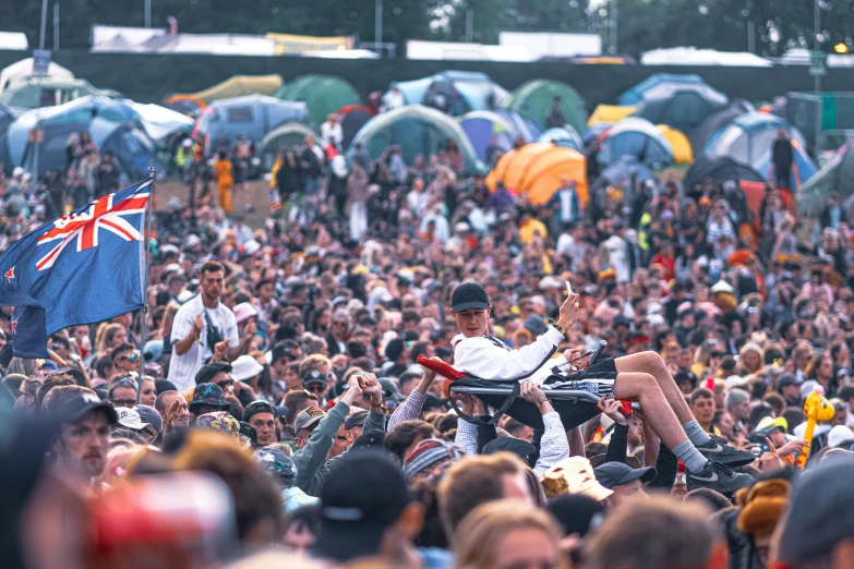 a large crowd of people at a music festival, unsplash, where's wally, reggae, 1 9 9 8 photo, barrel fires and tents