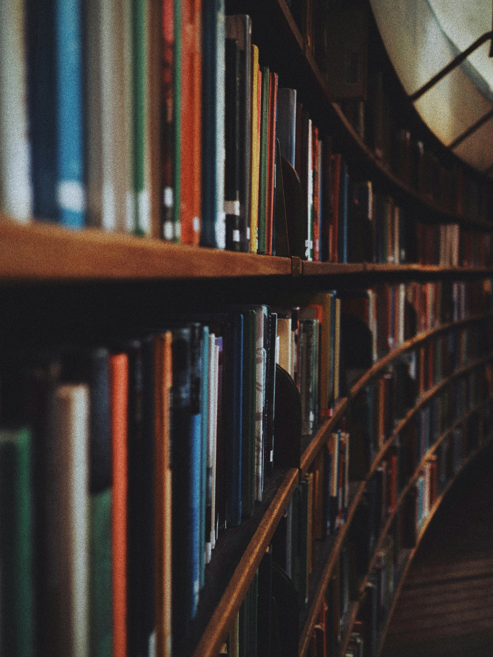 a bookshelf filled with lots of books next to a clock, trending on unsplash, grainy quality, profile picture, up close, 🚿🗝📝