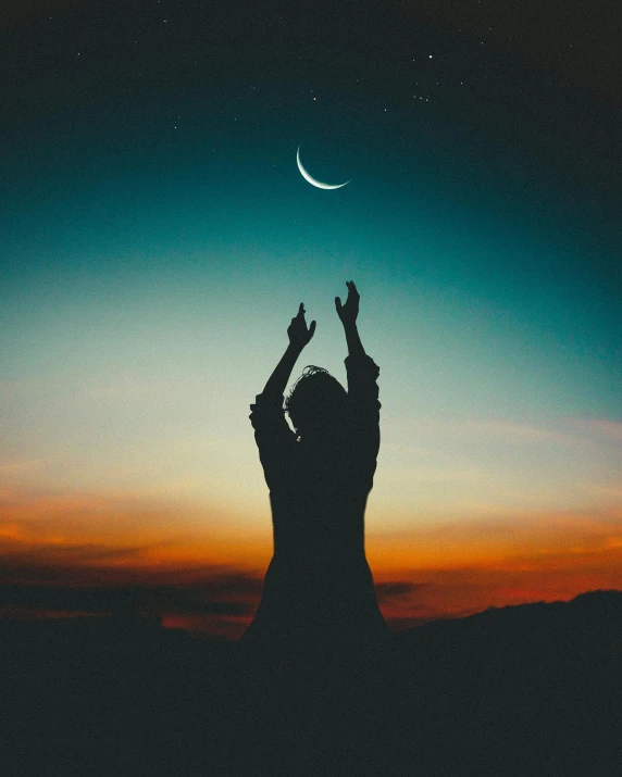 a person reaching up to the moon with their hands, trending on pexels, ☁🌪🌙👩🏾, holding a holy symbol, crescent moon, waving and smiling