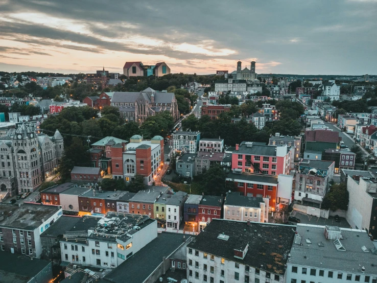 an aerial view of a city at dusk, by Daniel Lieske, pexels contest winner, quebec, red castle in background, grey, casually dressed