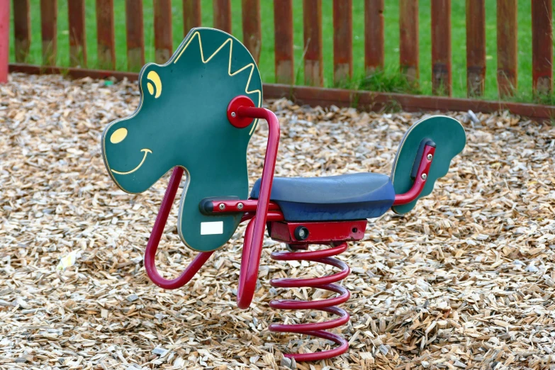 a green rocking horse sitting on top of a playground, inspired by Adam Rex, dribble, multi - coloured, the gruffalo, flying screw, slate