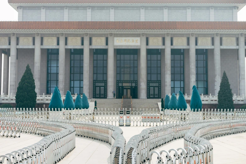 a large building with a white fence in front of it, inspired by Fei Danxu, tiananmen square, benches, 2022 photograph, colonnade