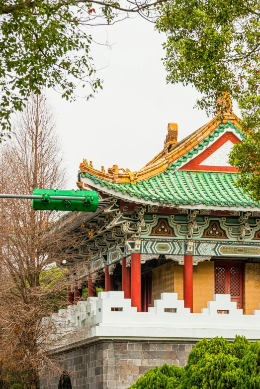 a building sitting on top of a lush green field, inspired by Shen Quan, cloisonnism, in front of a temple, jiang sword, over the shoulder, tokyo kowloon