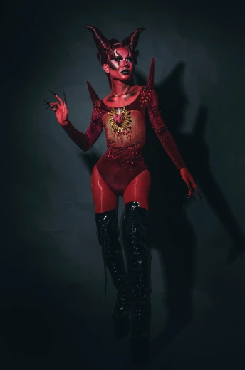 a woman in a devil costume posing for a picture, an album cover, inspired by Taro Yamamoto, featured on zbrush central, dark skin, laserpunk fullbodysuit, high quality photo, made of blood