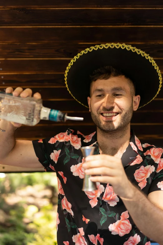a man in a sombren holding a bottle of tequila, by Adam Dario Keel, wearing a silly hat, lachlan bailey, rectangle, profile image
