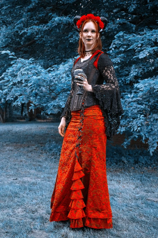 a woman in a red dress standing in a field, an album cover, inspired by Eleanor Fortescue-Brickdale, pixabay contest winner, wearing jacket and skirt, in detailed steampunk dress, clothed in ancient street wear, black and orange