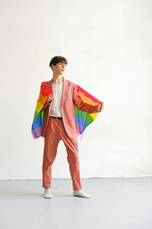 a man in a pink suit holding a rainbow flag, by Jessie Alexandra Dick, neo-dada, male ulzzang, wearing pants, open jacket, instagram photo