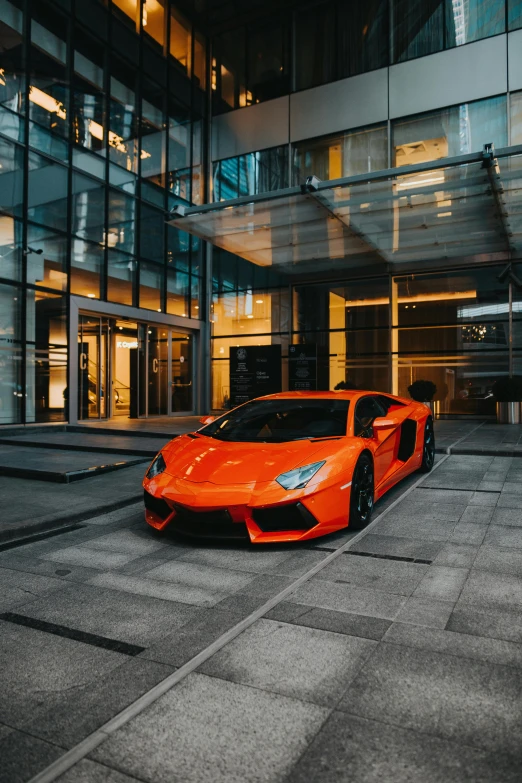 an orange sports car parked in front of a building, pexels contest winner, wealthy, stealth, instagram photo, indoor shot