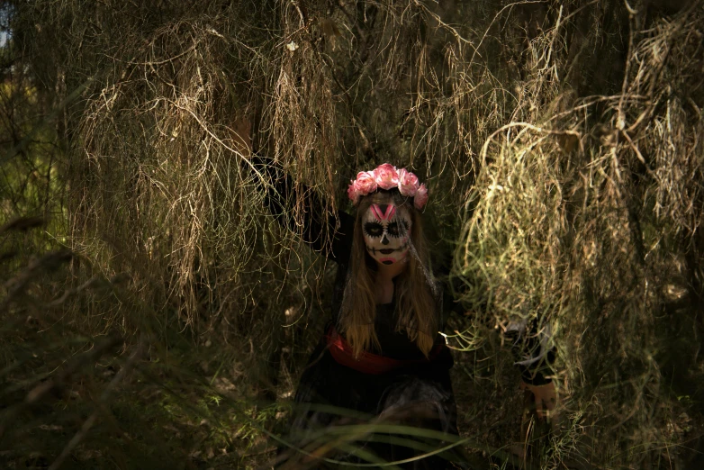 a woman that is sitting in the grass, day of the dead, an evil forest, photographed for reuters, lachlan bailey