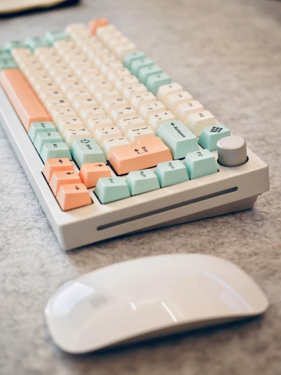 a computer keyboard sitting on top of a desk next to a mouse, by Andrew Stevovich, unsplash, computer art, orange pastel colors, white mechanical details, multiplayer set-piece, detailed product image