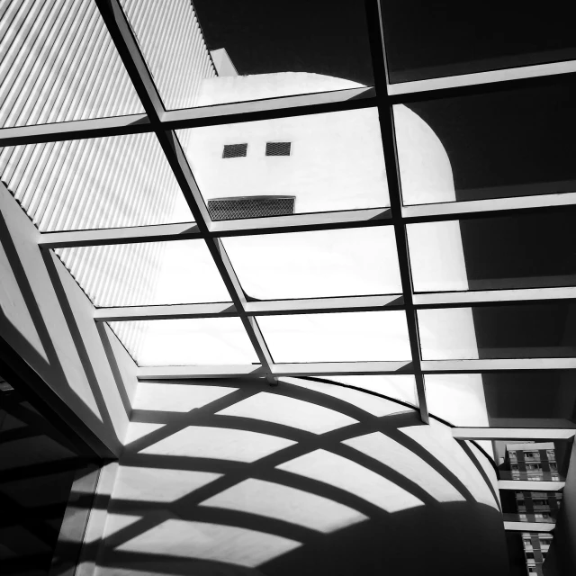 a black and white photo of the inside of a building, inspired by Vassily Maximov, unsplash contest winner, light and space, shadowed face, sunny sky light, square lines, rounded roof