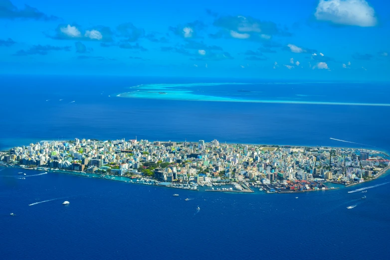 a small island in the middle of the ocean, pexels contest winner, hurufiyya, tropical coastal city, maldives in background, blue ocean, savannah