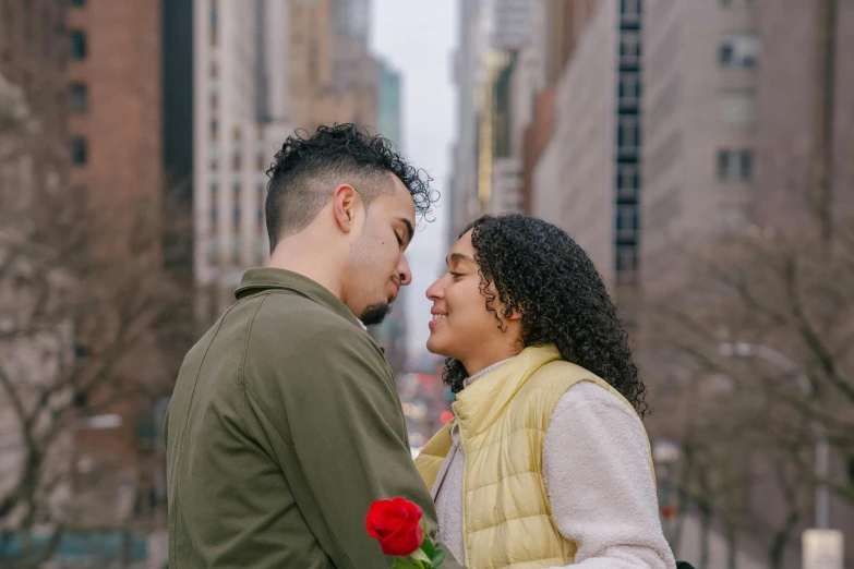 a man standing next to a woman holding a rose, pexels contest winner, in new york city, hispanic, 😭🤮 💔, flowers on heir cheeks