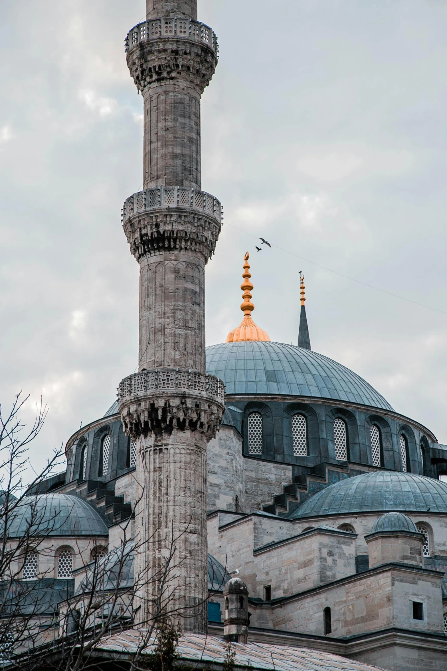 a tall building with a clock on top of it, inspired by Altoon Sultan, trending on pexels, hurufiyya, with great domes and arches, marbled columns, lead - covered spire, shot from roofline