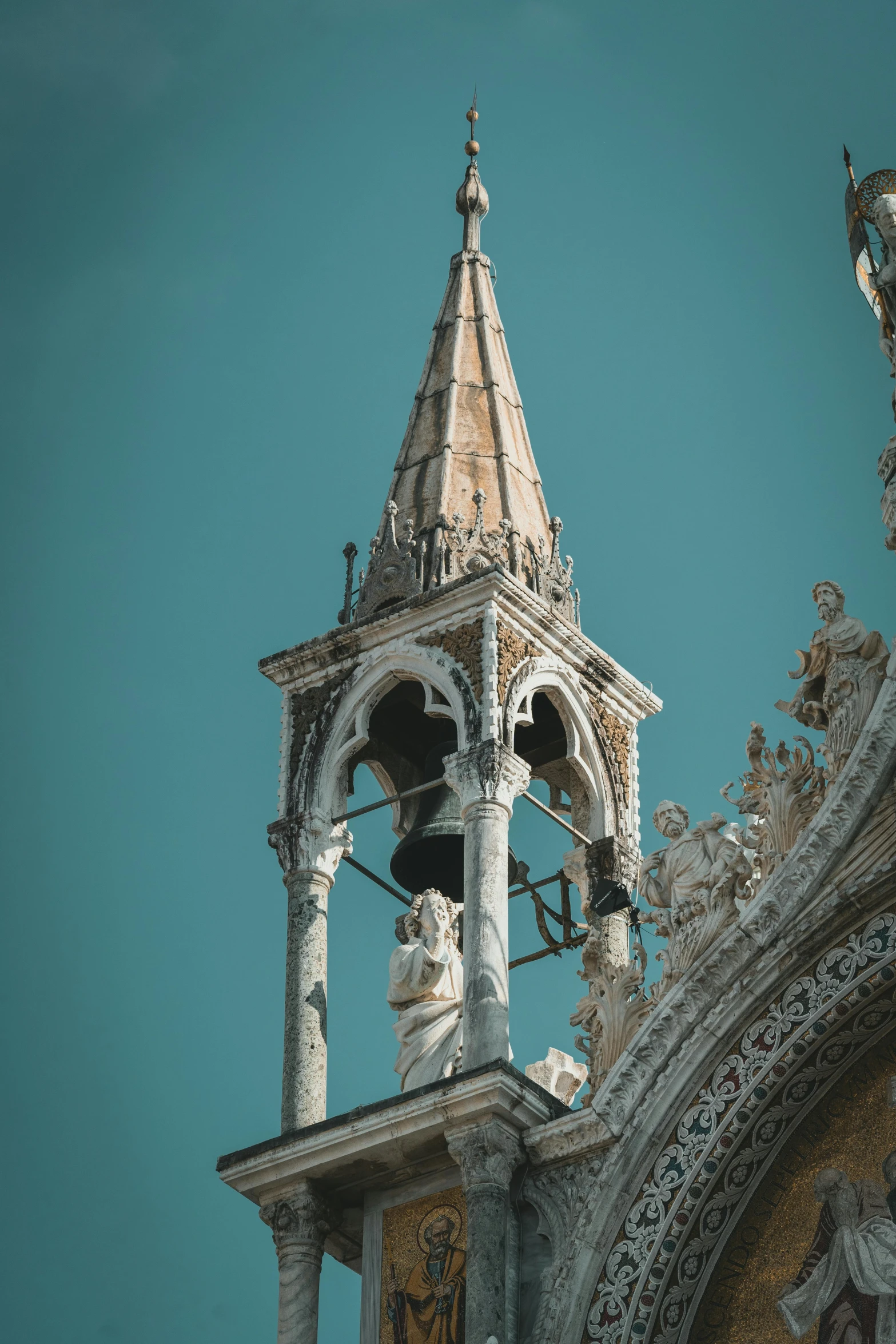 a clock that is on the side of a building, a statue, inspired by Quirizio di Giovanni da Murano, unsplash contest winner, baroque, asymmetrical spires, brown and cyan color scheme, gondola, looking from slightly below