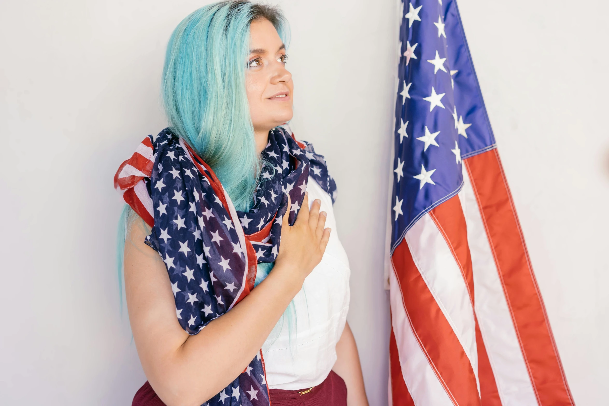 a woman with blue hair standing next to an american flag, pexels contest winner, scarf, violet myers, brittney lee, 30 years old woman