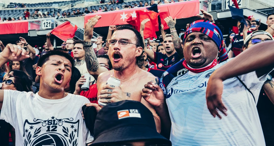 a group of men standing next to each other at a soccer game, pexels contest winner, happening, photograph of three ravers, chicago, venomized, sports illustrated