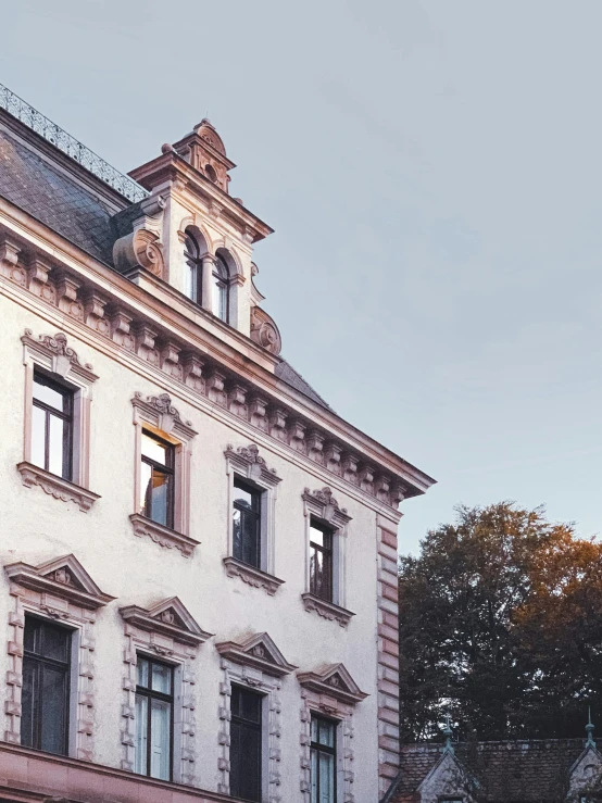 a building with a clock on the front of it, inspired by Mihály Munkácsy, pexels contest winner, mansion, profile image, kreuzberg, late summer evening