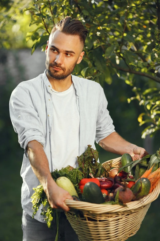 a man holding a basket full of vegetables, a stock photo, pexels contest winner, renaissance, handsome young man, lush surroundings, lgbtq, maxim sukharev