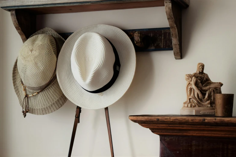 a white hat sitting on top of a wooden shelf, a still life, unsplash, arts and crafts movement, faded fedora, very sunny, over-shoulder shot, we go