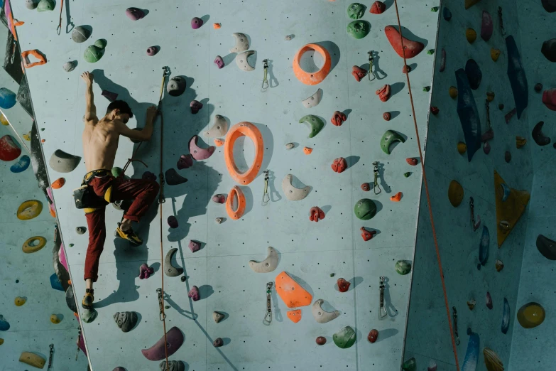 a man climbing up the side of a rock wall, pexels contest winner, local gym, avatar image, panels, old color photo